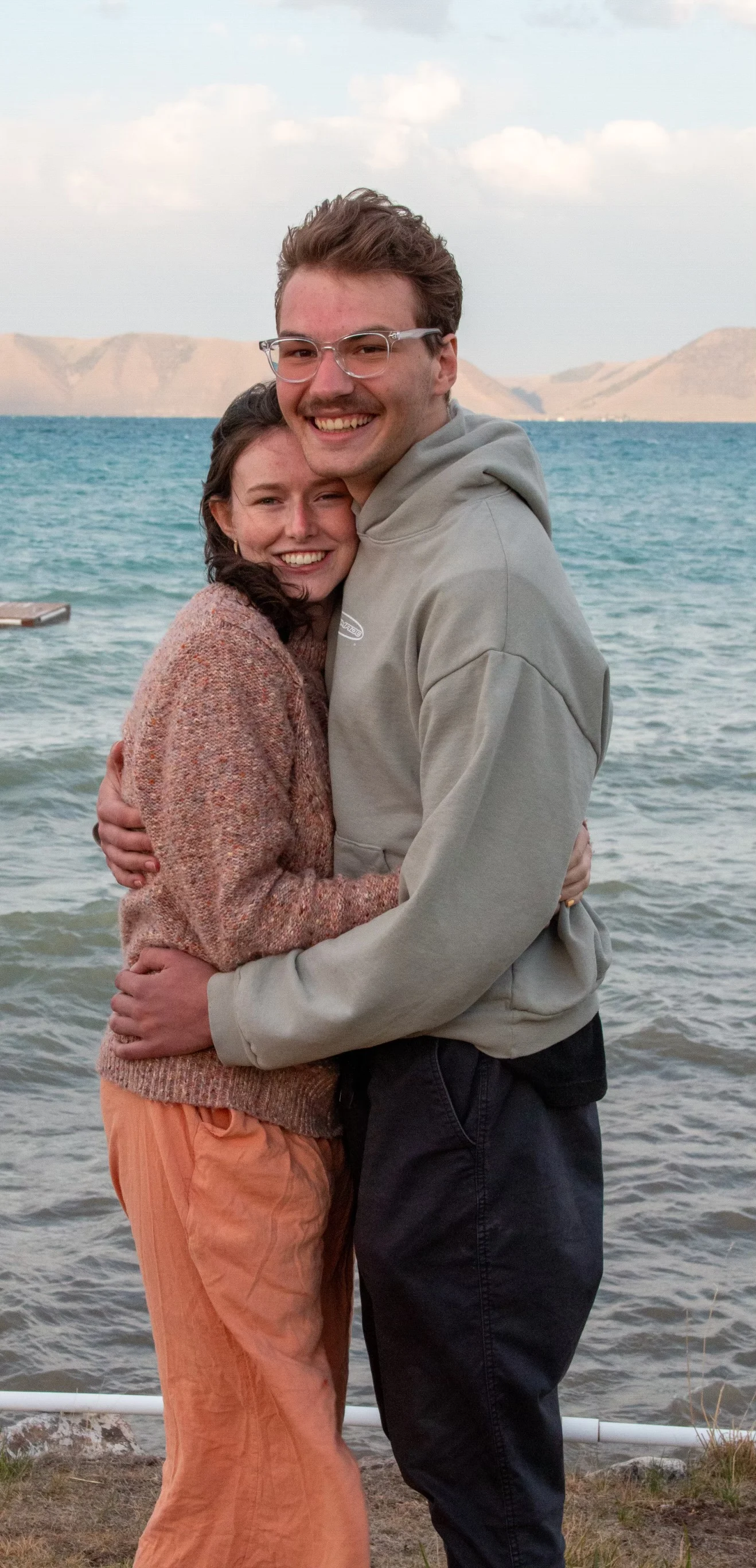 Blake and Riley hugging on the shore of Bear Lake